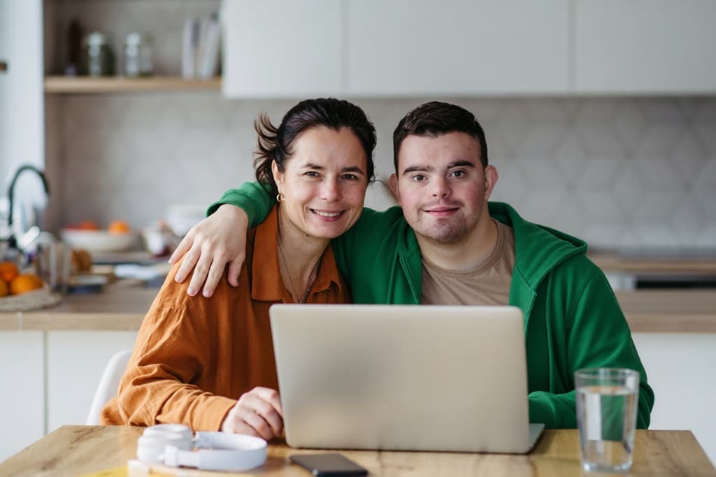 A participant and family member using a laptop together